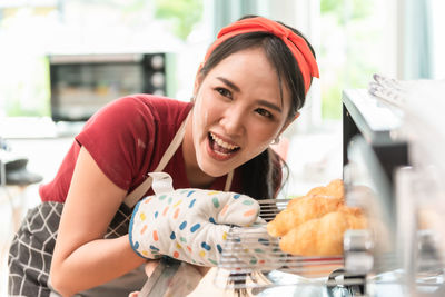 Happy chef preparing food in microwave