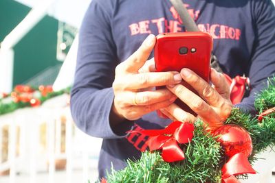 Close-up of man holding christmas decoration