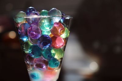 Close-up of multi colored candies in glass on table