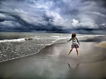 Girl jumping at beach