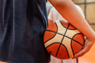 Midsection of man playing with ball