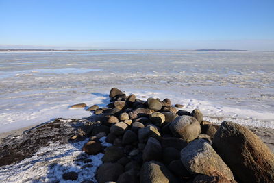 Rocks on beach against sky