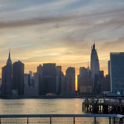 Buildings in city at sunset