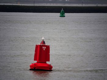 Red container ship in sea