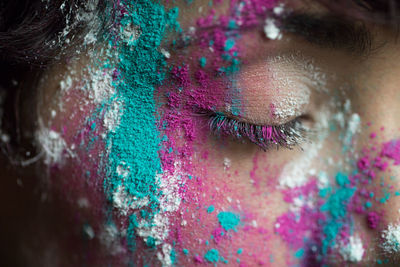 Woman with multi colored paints on face