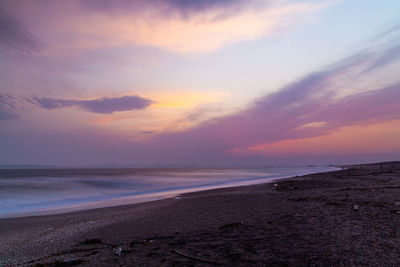 Scenic view of beach against sky during sunset