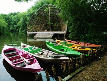 Boats moored in lake against sky