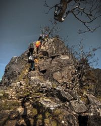 Low angle view of rocks on mountain against sky