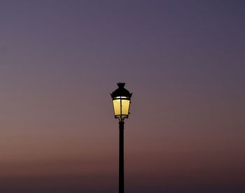 Low angle view of street light against sky during sunset