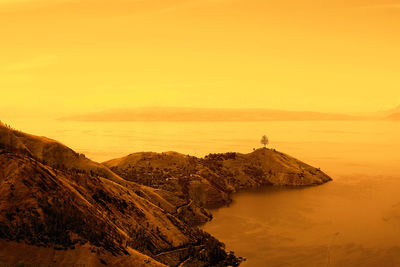 Scenic view of mountain against sky during sunset