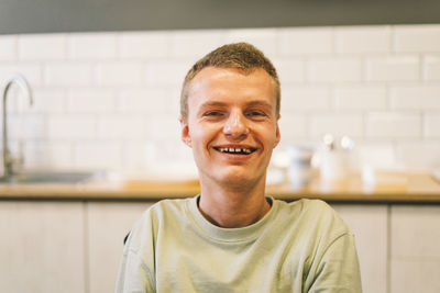 Portrait of young man handicapped with disabilities. optimistic smiling disabled man.