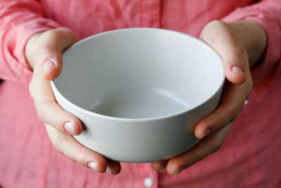 Midsection of woman holding bowl