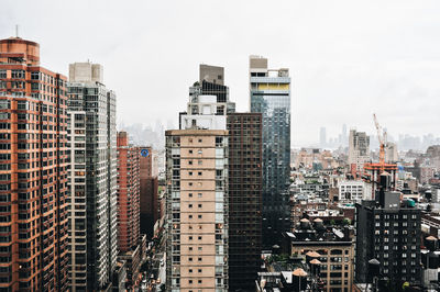 Buildings in city against sky