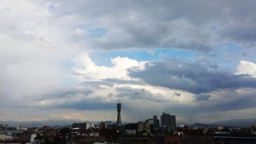 Buildings against cloudy sky