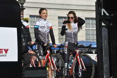 Full length of friends standing by bicycle