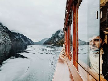 Man looking through boat window