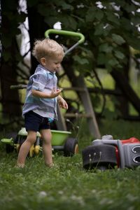 Portrait of boy playing with toy on field