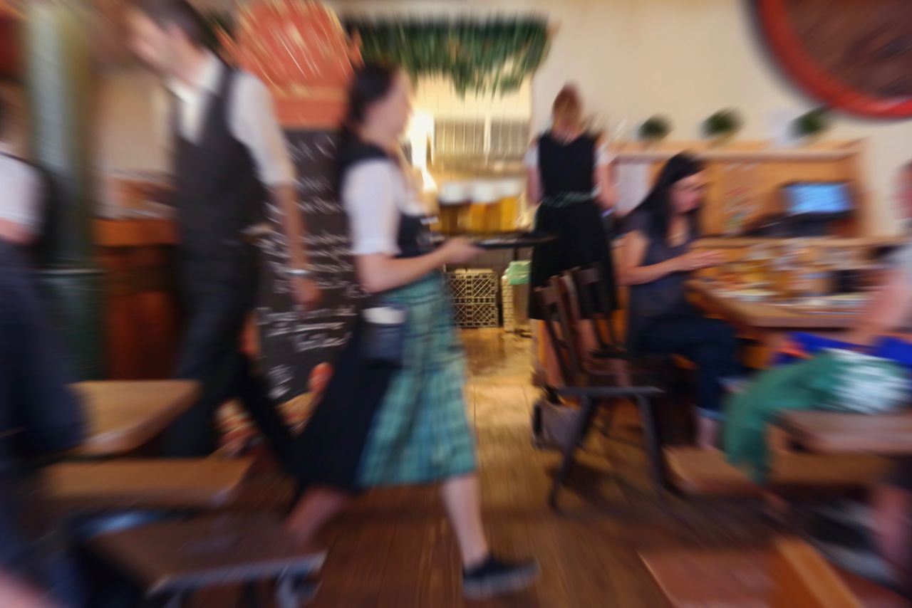 BLURRED MOTION OF PEOPLE WALKING IN CITY STREET