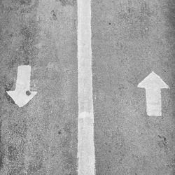 High angle view of arrow sign on road