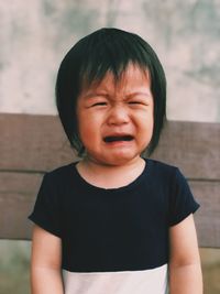 Close-up of cute girl crying outdoors