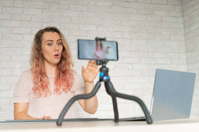 Portrait of young woman using digital tablet