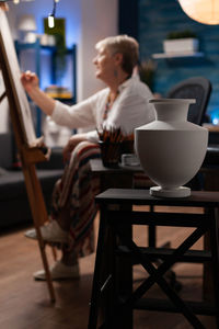 Side view of woman using laptop at home