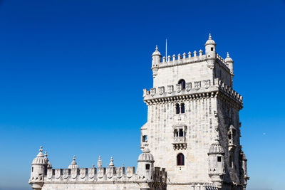 Low angle view of historical building against blue sky