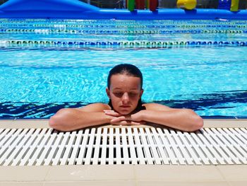 Portrait of young man swimming in pool
