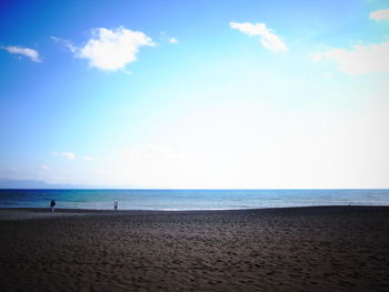 Scenic view of beach against blue sky