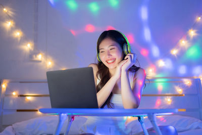 Young woman using mobile phone at night