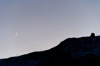 Low angle view of silhouette mountain against sky at dusk