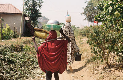 Rear view of senior man standing by plants