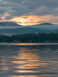 Scenic view of lake against romantic sky at sunset