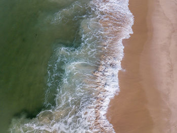 High angle view of surf on beach