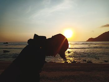 Silhouette man on beach during sunset