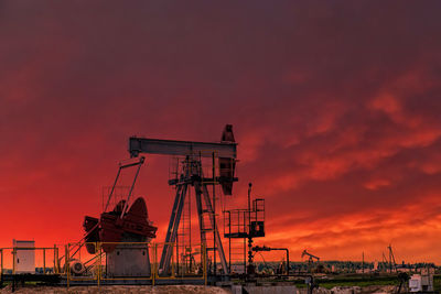 Oil drill rig and pump jack at sunset background. oil production from ground. drilling rigs 