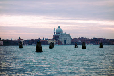 View of sea and buildings against sky