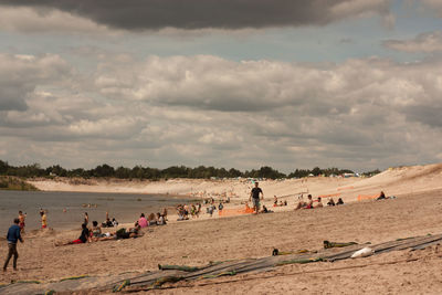 People on beach against sky