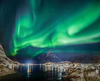 Scenic view of snowcapped mountains against sky at night