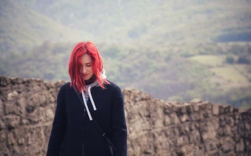 Portrait of smiling young woman standing outdoors
