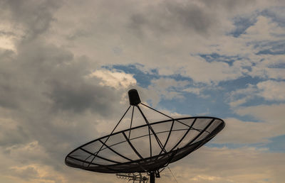 Low angle view of communications tower against sky