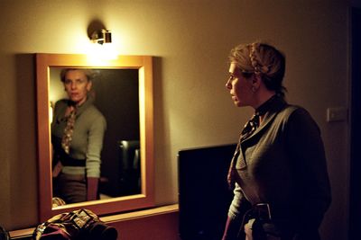 Woman standing in front of mirror at home