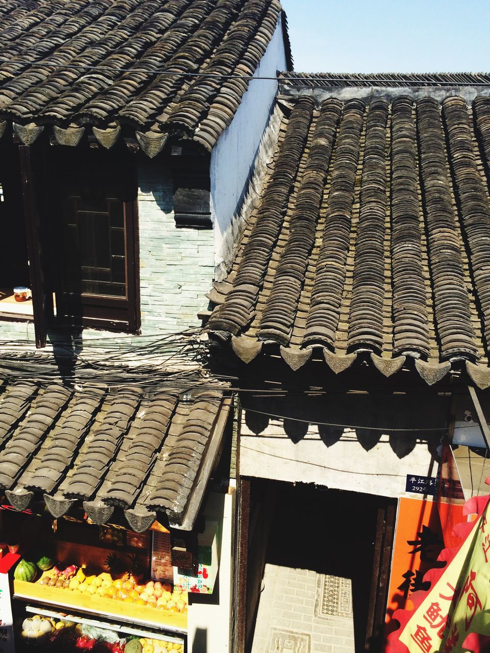 building exterior, architecture, built structure, roof, low angle view, place of worship, spirituality, religion, residential structure, residential building, house, roof tile, day, building, outdoors, city, clear sky, sky, temple - building, no people