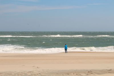 Full length of man on beach against sky