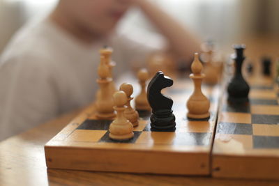 Close-up of chess pieces on table