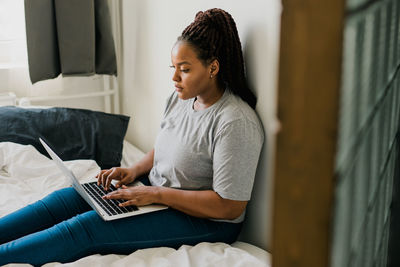 Young woman using laptop at home