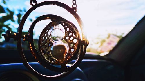 Close-up of hourglass hanging in car