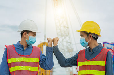 Young man wearing hat standing at construction site