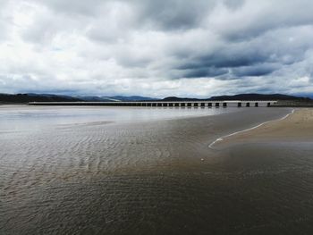 View of beach against cloudy sky