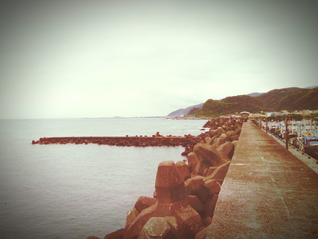 sea, water, sky, transfer print, tranquil scene, tranquility, clear sky, horizon over water, auto post production filter, pier, scenics, built structure, copy space, nature, railing, beauty in nature, beach, rock - object, the way forward, outdoors